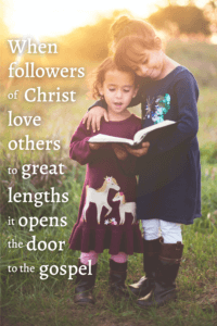 Link to Pinterest pin image of two young girls outdoors reading the Bible together with text that reads "When followers of Christ love others to great lengths it opens the door to the gospel". 