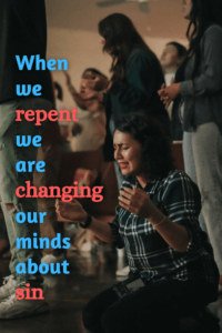 link to Pinterest pin image of people worshipping with young woman in foreground on knees in intense prayer with text "When we repent we are changing our minds about sin". 