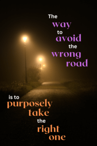Link to Pinterest pin image of foggy road at night, lit by streetlights with text that reads "The way to avoid the wrong road is to purposely take the right one."