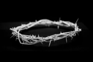 A black and white picture of a crown of thorns. There are 4 times Jesus predicts His death and resurrection in the Gospels.