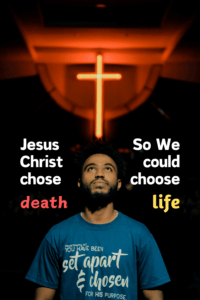 Photo of an African-American man looking up at a neon cross in church with a caption that says Jesus Christ chose death so we could choose life
